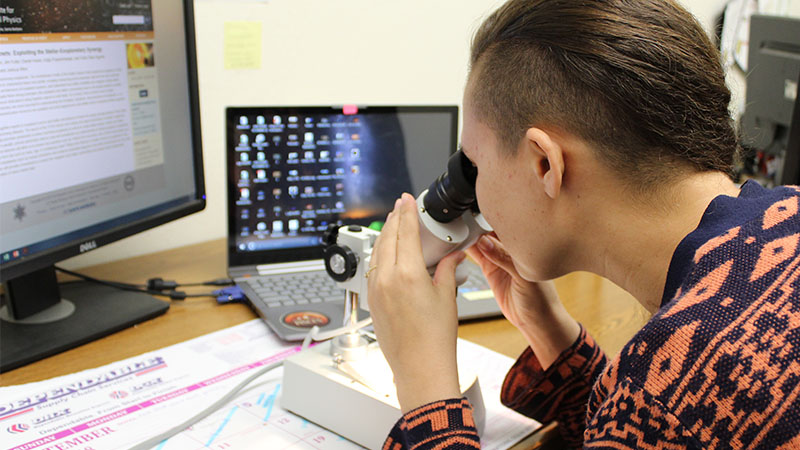 staff member using microscope