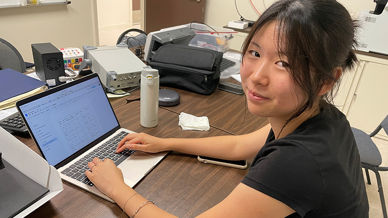 Intern Za-Ting Huang at her laptop.