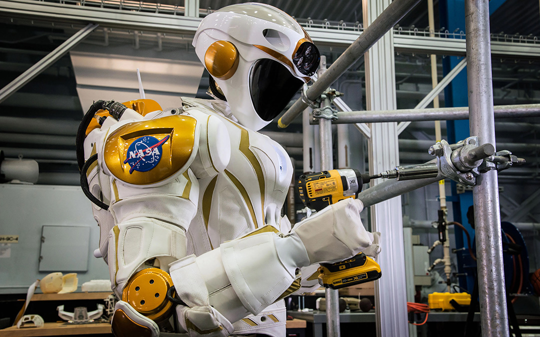 NASA's Valkyrie humanoid robot holding an electric drill.