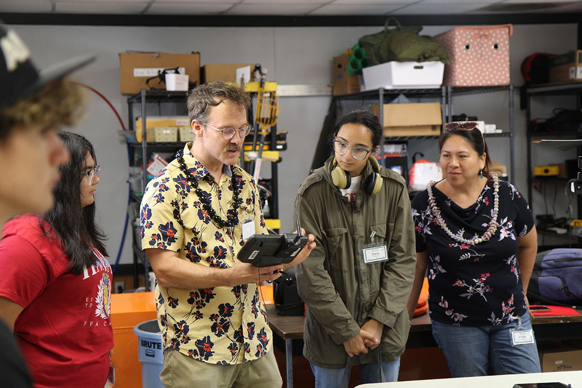 Dr. Ryan Perroy demonstrates a LiDAR mapping system to students at the Spatial Data Analysis and Visualization Lab at UH Hilo during GIS Day 2025.
